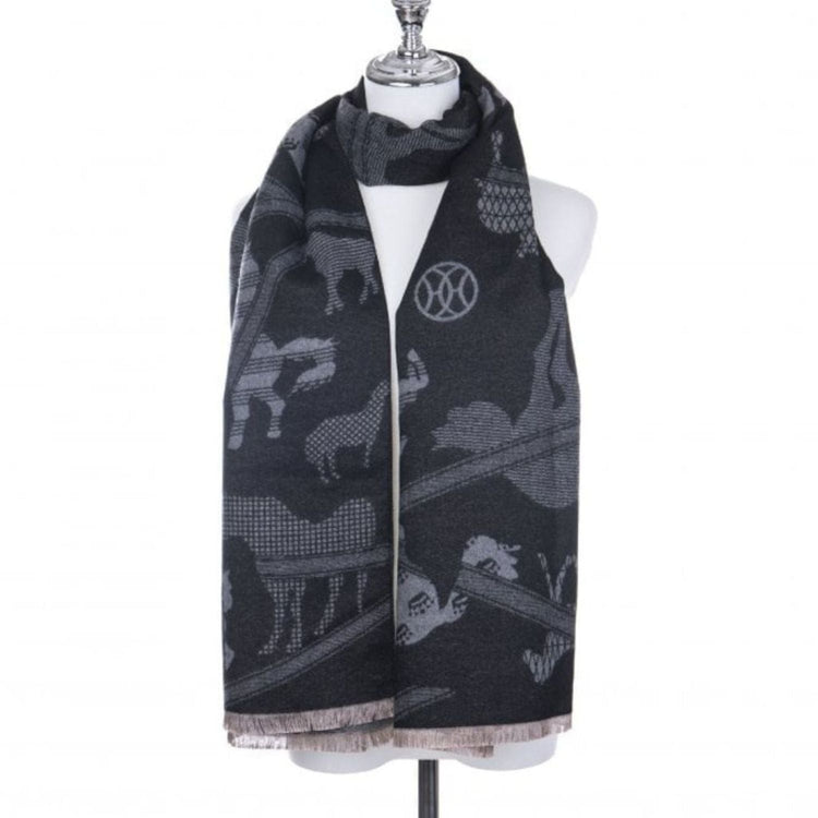 A black and gray scarf with animal patterns draped around a dress form mannequin, featuring various animal silhouettes and light fringe at the ends.
