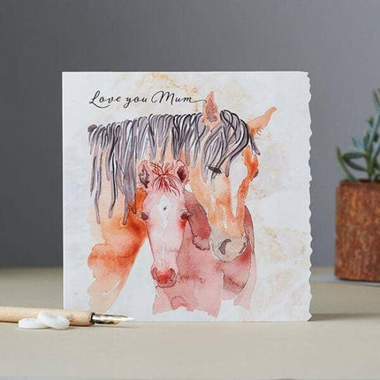 Watercolor illustration of a mare and foal close together, with the text Love you Mum written above them on a textured, creamy background with a scalloped edge on the right.