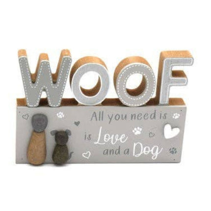 wooden block sign with woof in large cut out letters on top with the writing all you need is love and a dog