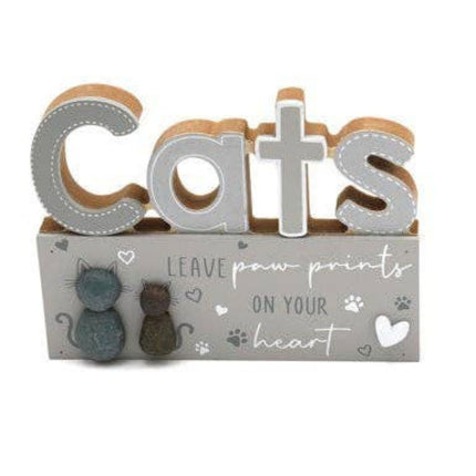 wooden block sign with cats in large cut out letters and the writing leave paw prints on your heart