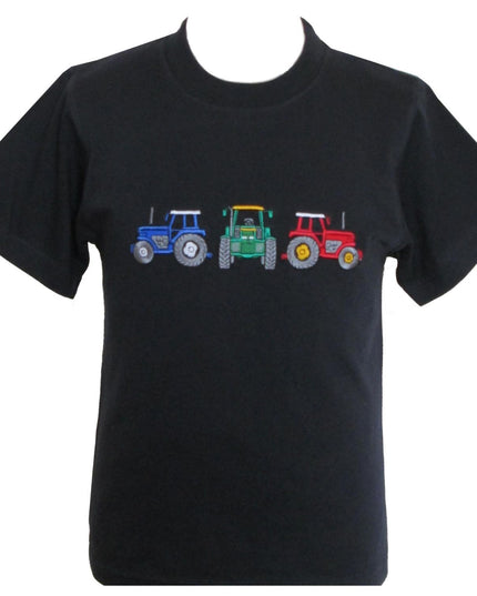 The British Country Collection Farm T Shirt Tractor Design Black Childrens is a 100% cotton tee featuring an embroidered row of tractorsâ€”blue, green, and redâ€”perfect for kids who love farming.