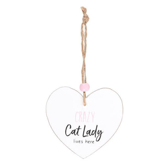 a heart shaped sign which reads crazy cat lady lives here, suspended by a piece of twine and finished with a wooden bead