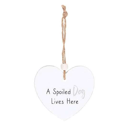 a heart shaped sign which reads a spoilt dog lives here, suspended by a piece of twine and finished with a wooden bead