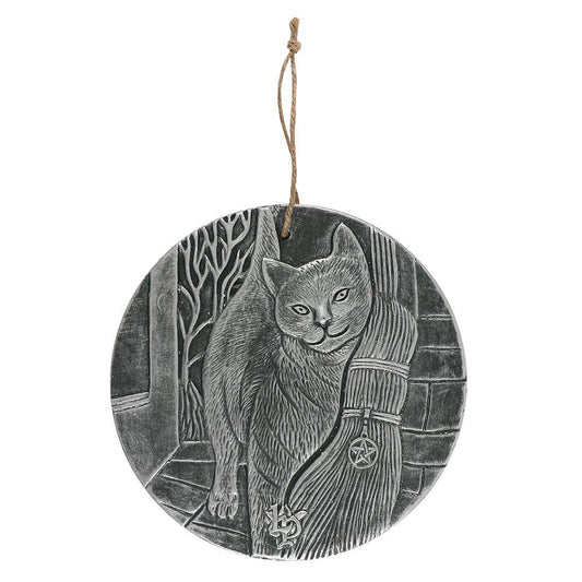 a silver coloured wall plaque featuring a cat with a witches broom