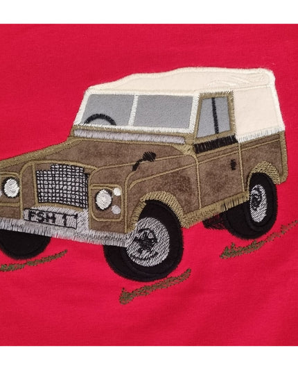The Ramblers Embroidered T Shirt Farm Vehicle Childrens features a brown vintage off-road farm vehicle with a white roof on red fabric, detailed stitching on wheels, grill, and windowsâ€”ideal for charming any childâ€™s wardrobe.