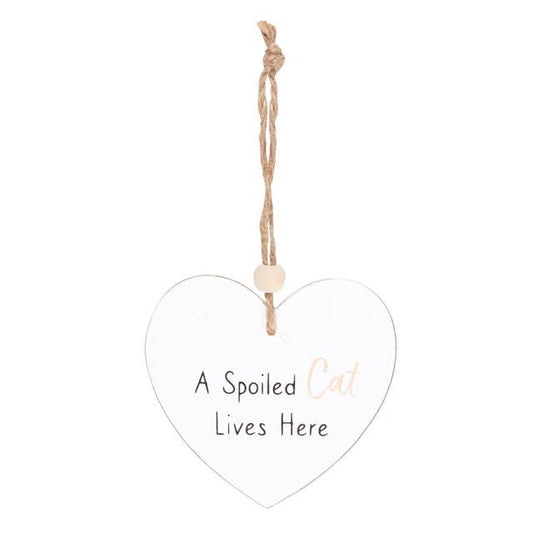 a heart shaped sign which reads a spoilt cat lives here, suspended by a piece of twine and finished with a wooden bead