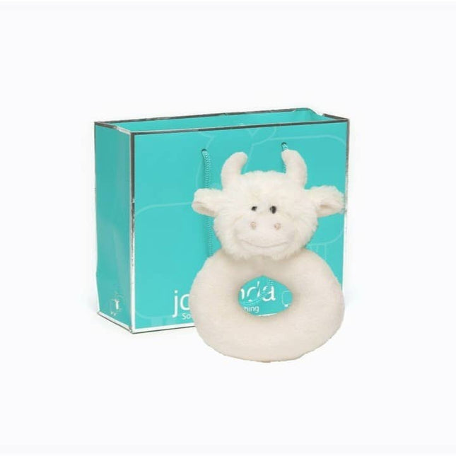 A plush white cow rattle sits in front of the Gift Bag Small Jomanda by Jomanda Soft Toys & Accessories—an adorable addition to any collection of mini toys.