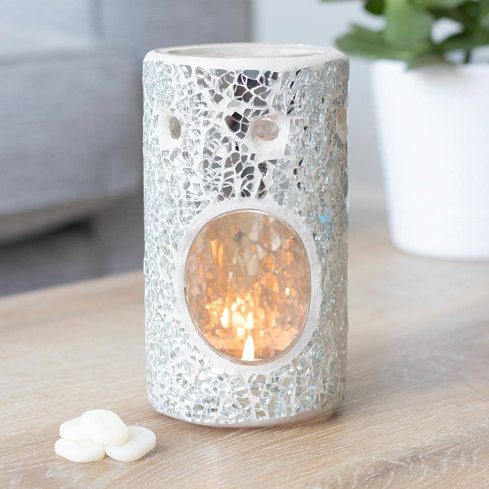 pillar-shaped oil burner, featuring a silver mirrored crackle effect with a lit tea light with some wax melts next to it