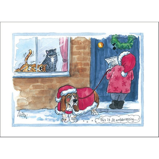 Funny dog Xmas card from Alisons Animals with a humorous cartoon design featuring an embarrassed Basset Hound dog dressed up as Santa's Helper being laughed at by two cats.