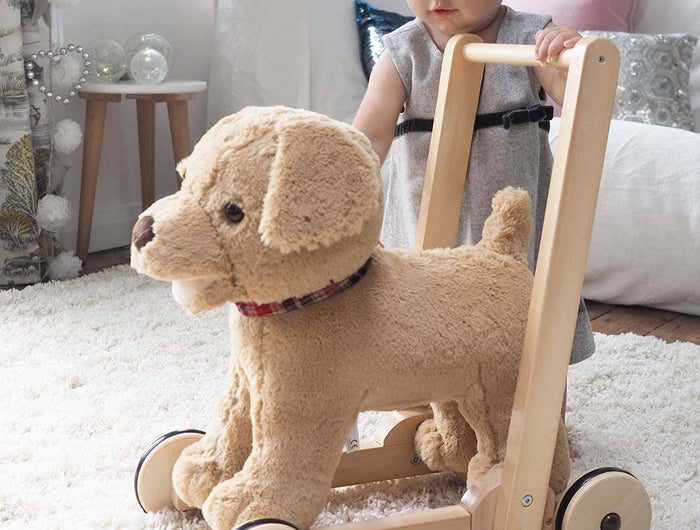 a baby playing with an adorable golden labrador soft toy puppy dexter dog infant push aong walker by Little Bird Told Me