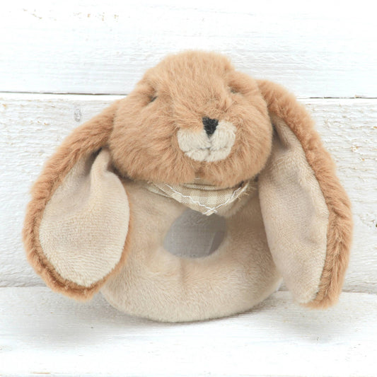 a round cream baby rattle with a cute brown floppy eared bunny head