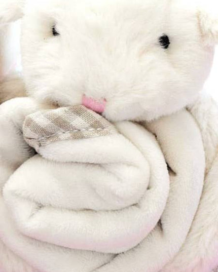 a close up view of a cream fluffy bunny with a soft blanket comforter wrapped up in his arms