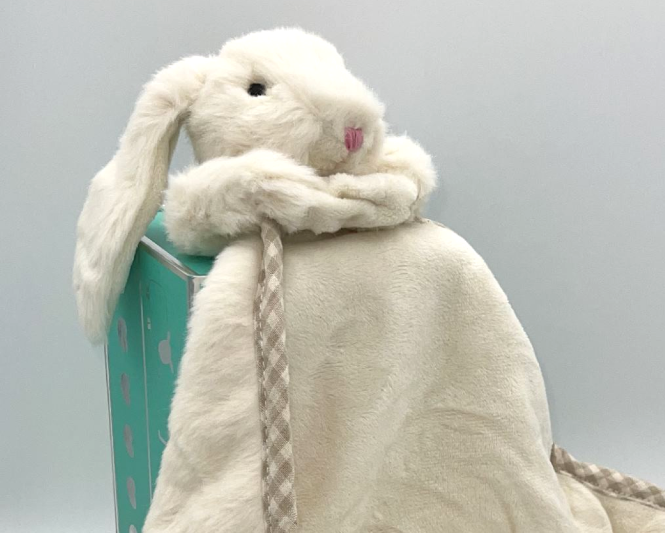 a cream fluffy bunny soft toy with floppy ears with a soft blanket comforter in a luxury gift box