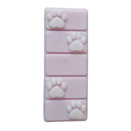 a pink wax melt bar with white paw prints