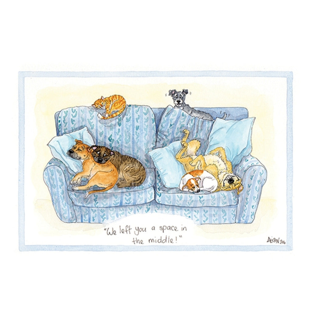 a funny dog greeting card with a cartoon drawing of dogs and cats lying on a sofa with the caption we left you a space in the middle