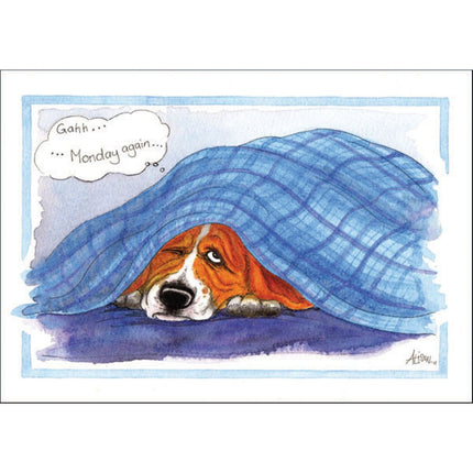 A tired dog lies under a blue plaid blanket with one eye open, looking unhappy, as a thought bubble reads â€œGahh...Monday again.â€ This Alisons Animals Funny Dog Card is perfect for dog lovers who know that Monday feeling!.