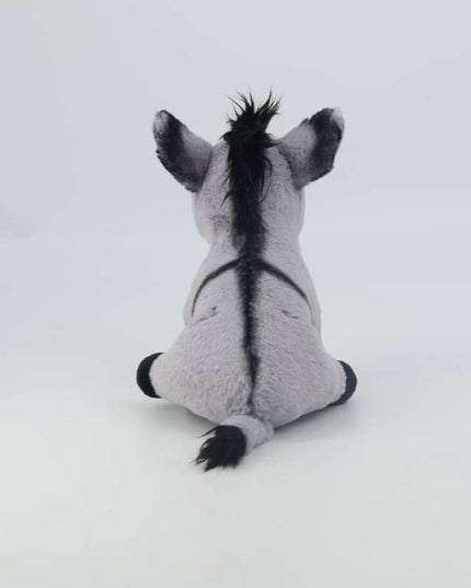 the back view of a grey soft toy donkey with black cross on his back