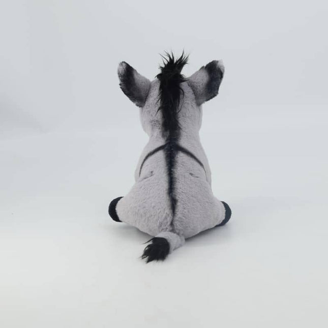 the back view of a grey soft toy donkey with black cross on his back