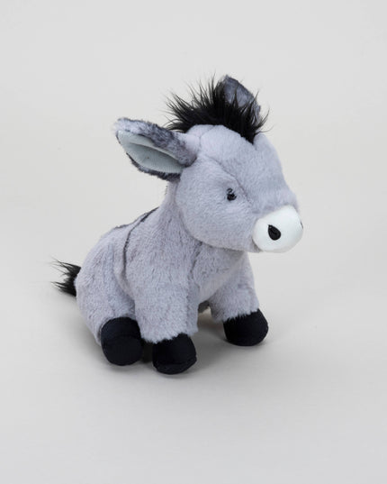 the side view of a grey soft toy donkey with white muzzle, black mane, tail and hooves