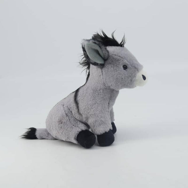 the side view of a grey soft toy donkey with white muzzle, black mane, tail, shoulder stripe and hooves