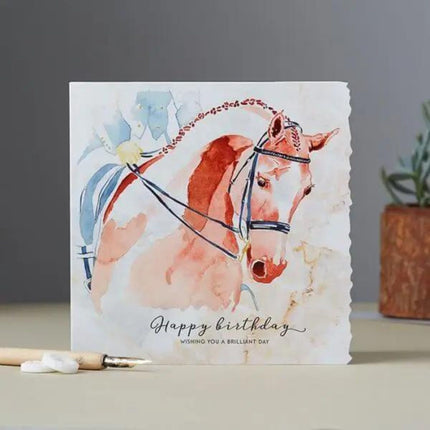 The Dressage Birthday Card Horse Head by Deckled Edge Ltd features a watercolor brown horse with bridle and Happy birthday. Wishing you a brilliant day. on the front—a perfect equestrian greeting card for horse lovers.