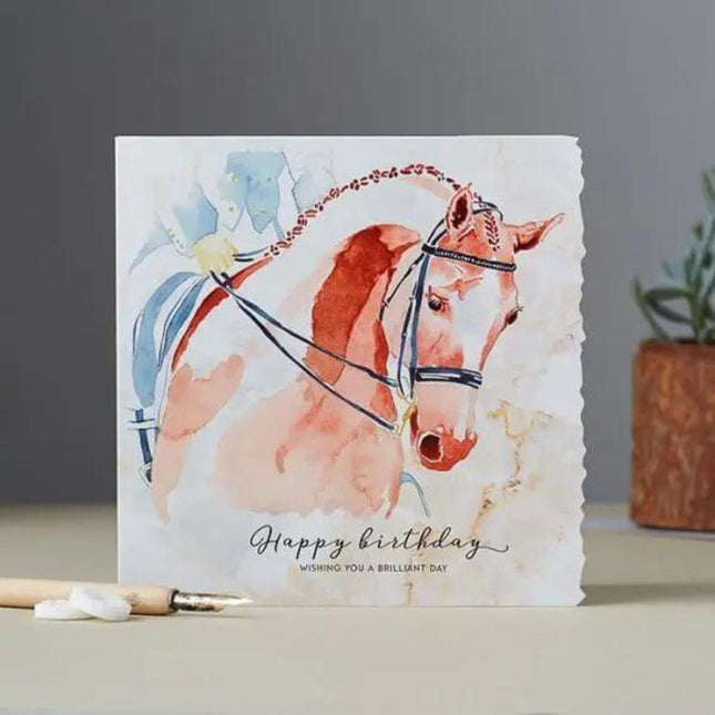 The Dressage Birthday Card Horse Head by Deckled Edge Ltd features a watercolor brown horse with bridle and Happy birthday. Wishing you a brilliant day. on the front—a perfect equestrian greeting card for horse lovers.