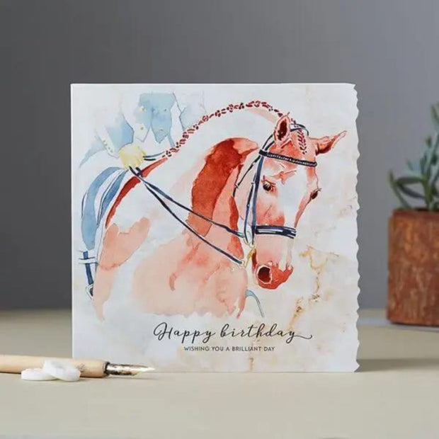 The Dressage Birthday Card Horse Head by Deckled Edge Ltd features a watercolor brown horse with bridle and Happy birthday. Wishing you a brilliant day. on the front—a perfect equestrian greeting card for horse lovers.