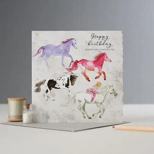 The Deckled Edge Ltd Horse Birthday Card features Janna Cossettini artwork—three colorful horses and a rider—with Happy Birthday wishing you a fantastic day. Blank inside, perfect for any horse lovers special day.