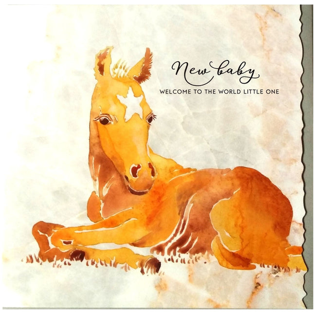 The Deckled Edge Ltd Horse Greeting Card “New Baby Welcome” features a watercolor chestnut foal with a white star, lying down, and the phrases “New Baby” and “Welcome to the world little one” on a soft horse-themed background.