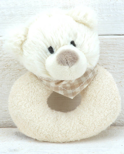 a cream plush rattle with a cute bears head