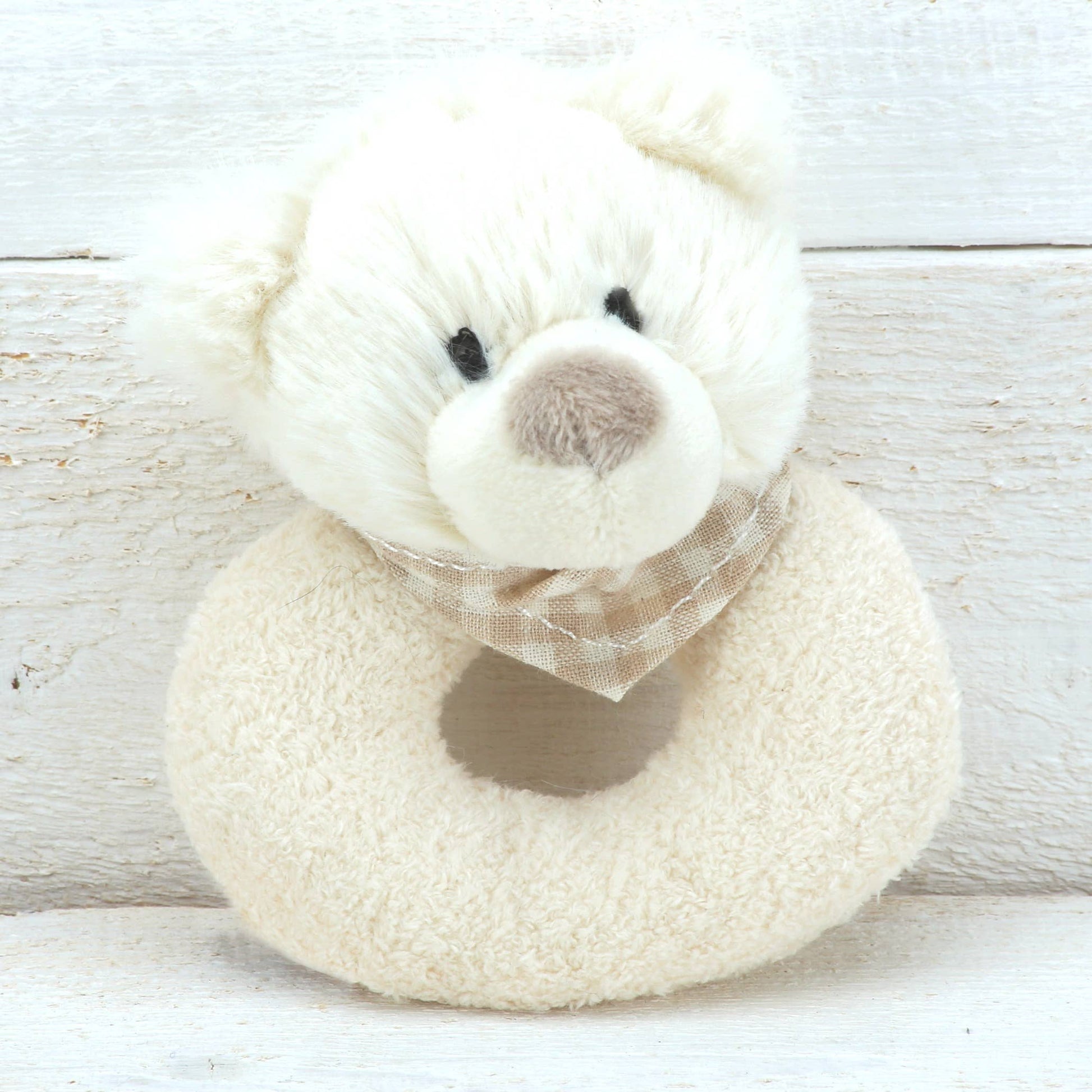 a cream plush rattle with a cute bears head