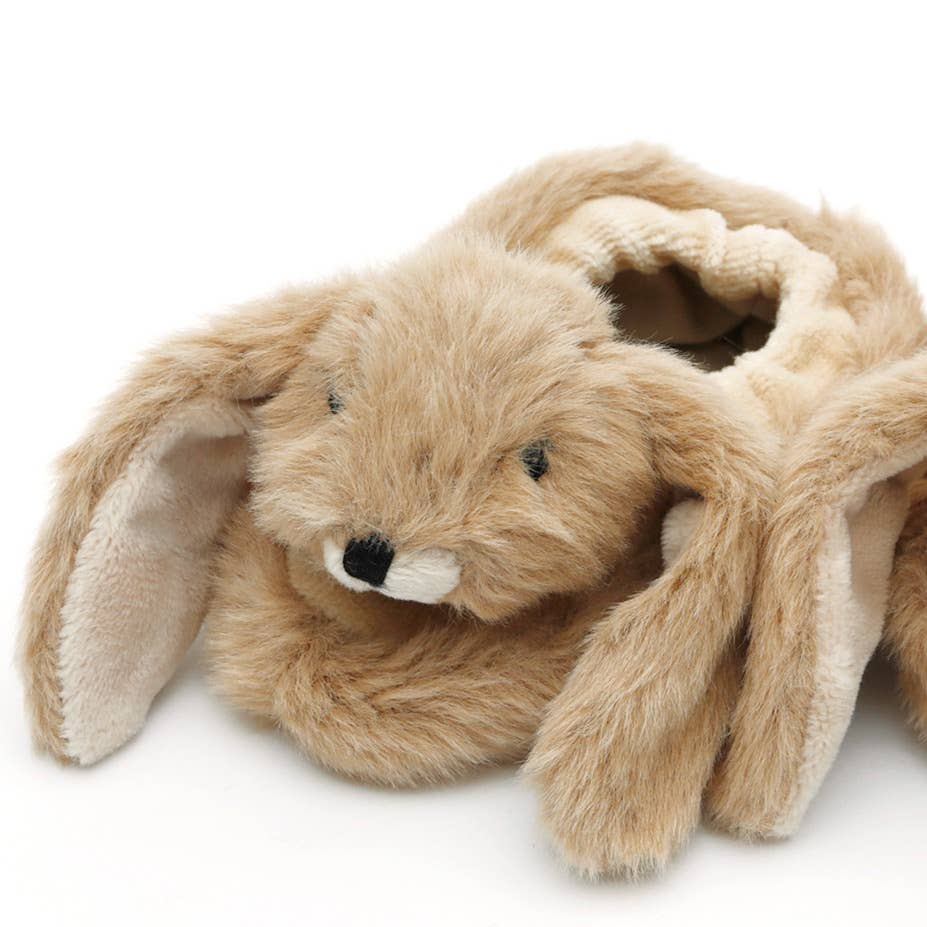 a close up shot of a bunny slipper baby booties made of very soft brown plush fur with a cute cream plush  lined floppy ears and cream nose