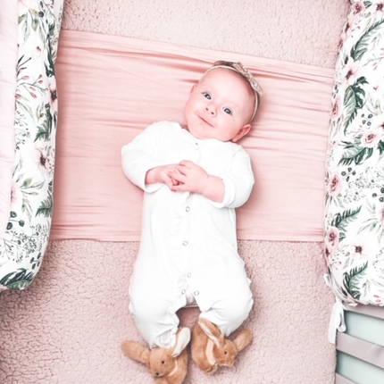 a pair of Jomanda soft plush bunny rabbit slippers for infants worn by a smiling baby