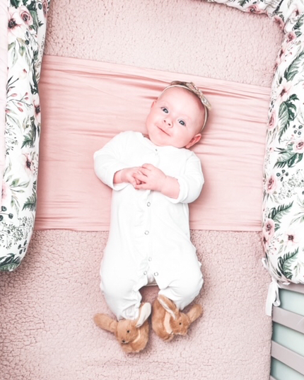 a pair of Jomanda soft plush bunny rabbit slippers for infants worn by a smiling baby