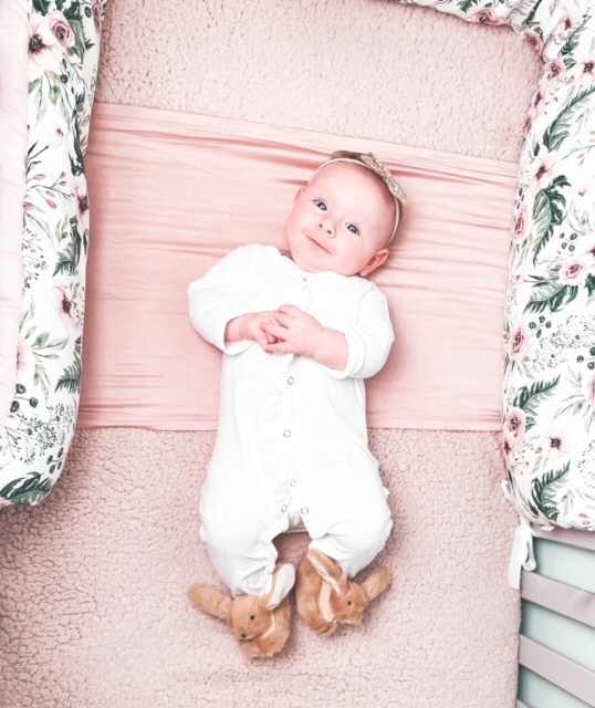 a pair of Jomanda soft plush bunny rabbit slippers for infants worn by a smiling baby