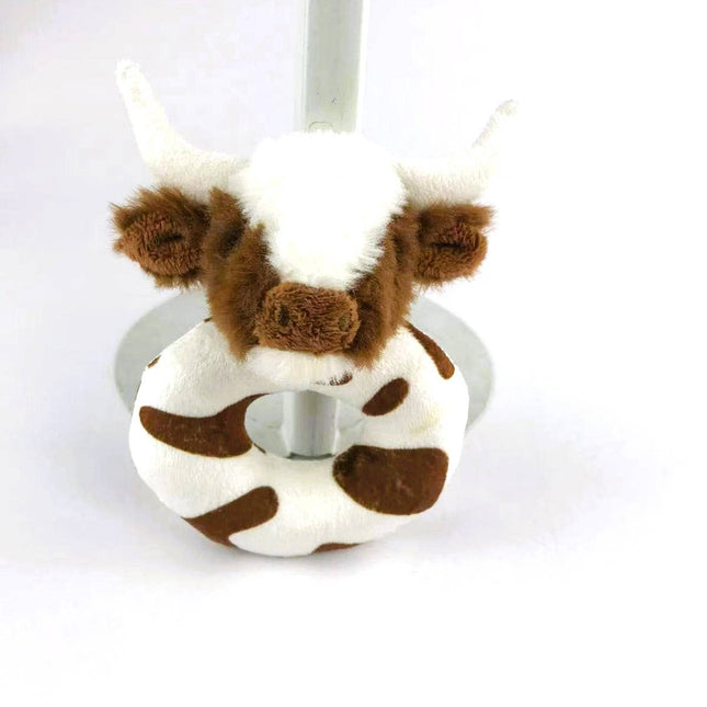 a soft plush circular brown and white baby rattle with a fluffy brown and white longhorn cow head