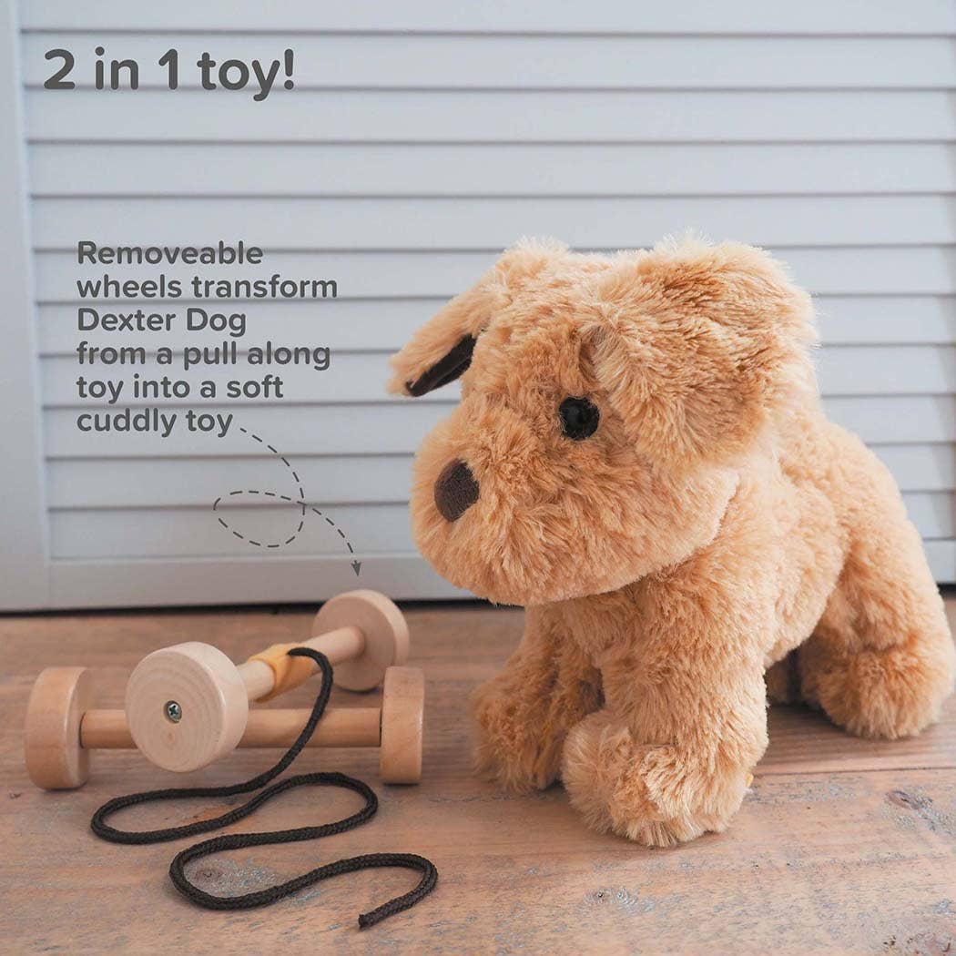 an adorable labrador puppy soft toy next to a set of removable wooden wheels with gorgeous golden soft fur made by little bird told me