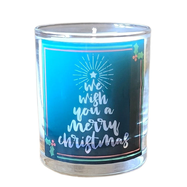 The Quaver&Lyric Christmas Scented Candle comes in a glass holder with Wish You A Merry Christmas text, holly leaves, and a star on blue—ideal festive home decor or a gift.