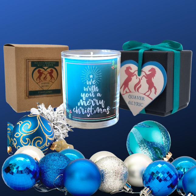 A festive set featuring Quaver&Lyric’s Christmas Scented Candle Wish You A Merry Christmas in a glass jar, blue and silver ornaments, a brown box, and a black gift box with ribbon—ideal Christmas home decor or gift.