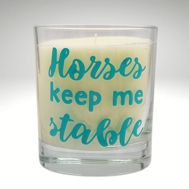 The Quaver&Lyric Scented Candle In Glass Container features teal Horses Keep Me Stable textâ€”a perfect handmade gift for horse lovers.