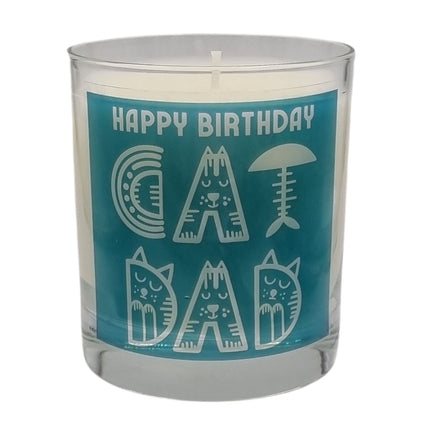 The Quaver&Lyric Scented Candle In Glass Container features a blue label reading Happy Birthday Cat Dad with playful cat and fish designs—a premium fragrance gift, perfect for any cat dad’s birthday.