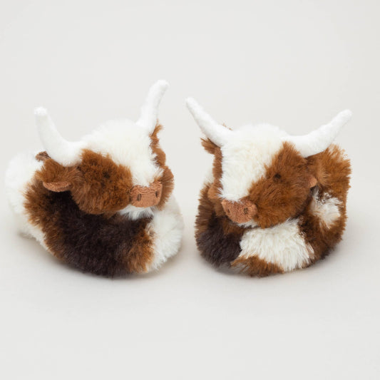 Two Texas Longhorn Cow Slippers For Infants by Jomanda Soft Toys & Accessories, featuring cute brown and white fur with white horns, are placed side by side on a plain background—an ideal gift or cozy baby booties.