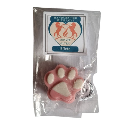 A pink and white, paw-shaped â€œHighly Scented Soy Wax Meltâ€ by Quaver&Lyric, wrapped and labeled â€œHandcrafted with Love,â€ features two red horses and a heartâ€”perfect for adding delightful fragrance to any space.