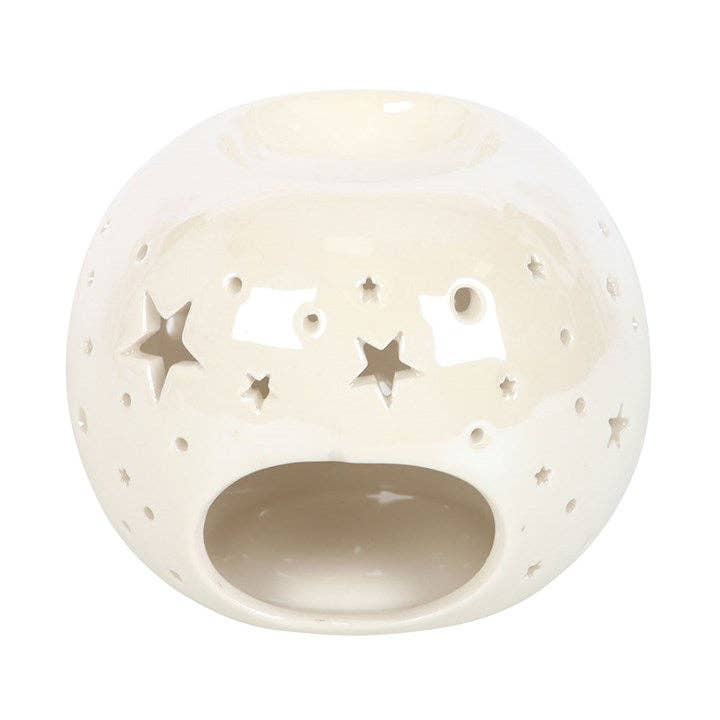 the back of a white spherical wax warmer with stars cut out and and irridescent finish