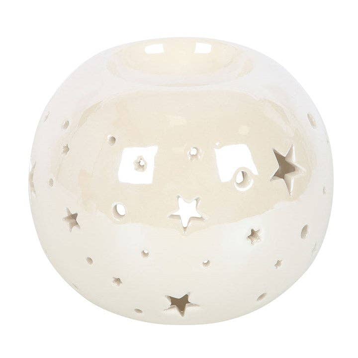 the front of a white spherical wax warmer with stars cut out and and irridescent finish