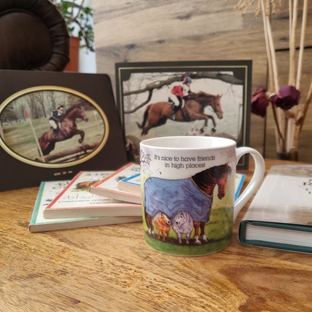 The Horse Mug Alisons Animals Gift Boxed by Alisons Animals sits on a wooden table with books and horse photos. Featuring the phrase It’s nice to have friends in high places, it’s perfect for animal lovers. Dried flowers add a cozy touch.