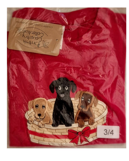 The British Country Collection Dog T Shirt features an embroidered basket of three puppies with a red bow. This childrens tee comes folded in plastic packaging with a tag and size label 3/4.