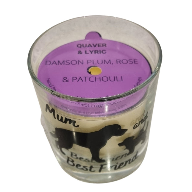 The Quaver&Lyric Scented Candle In Glass Container 20cl features dog silhouettes and Mum and Best Friend textâ€”an ideal gift for dog lovers, blending premium Damson Plum, Rose & Patchouli scents with a charming purple lid.