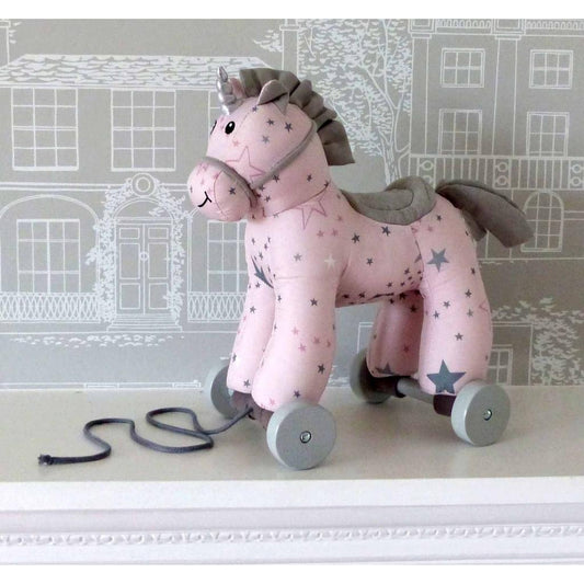 An adorable pink unicorn on detachable grey wheels. Her pink body is covered with grey and pink stars and she has a tactile mane and tail.