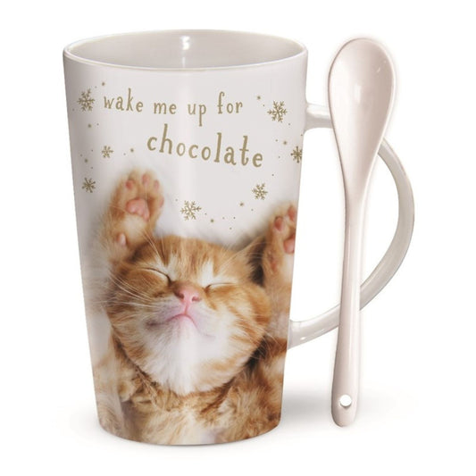 The Otter House Chocolatte Cat Mug and Spoon Cat Wake Me Up is a microwave-safe white mug with a sleeping orange kitten, golden snowflakes, and wake me up for chocolate text. Includes a ceramic spoon in the handleâ€”great gift for cat lovers.